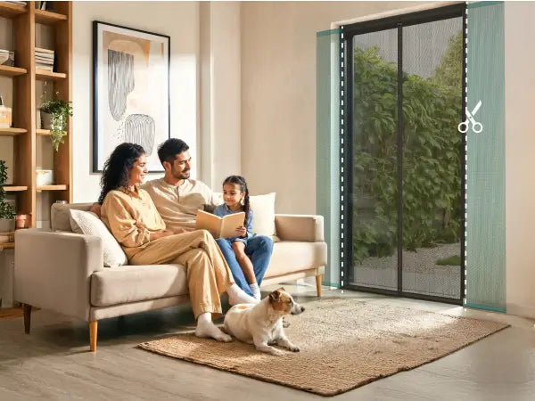 Family reading together on a couch with a dog in a modern living room and a magnetic screen door Varano